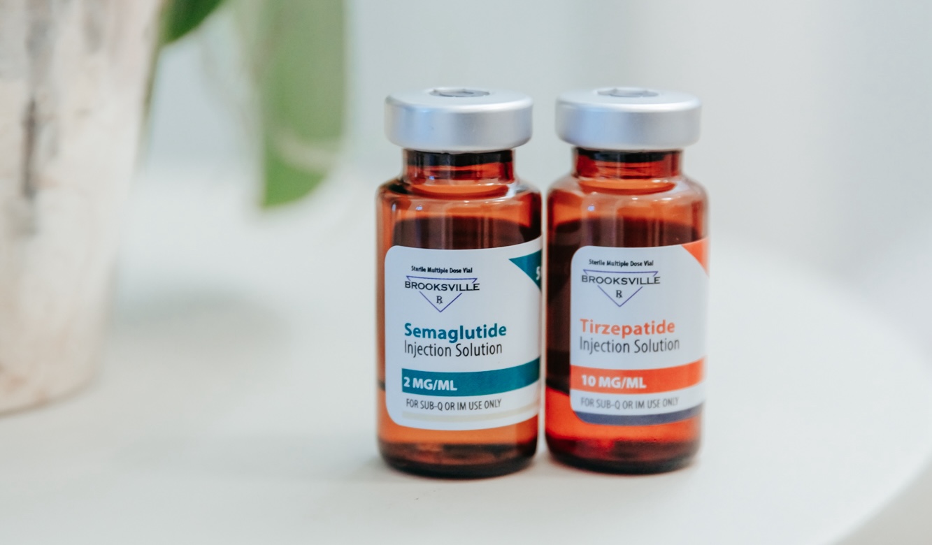 A close-up shot of 2 bottles, one for Semaglutide and one for Tirzepatide, our options for weight loss injections in Waxhaw.